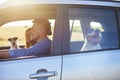 Young smiling couple and their two dogs traveling by car Royalty Free Stock Photo