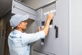 Young smiling electrician doing his work, electrical panel Royalty Free Stock Photo