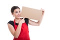 Young smiling employee pointing finger at moving box