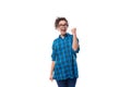 young smiling energetic curly european woman dressed casually in a blue plaid shirt on a white background Royalty Free Stock Photo