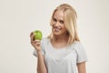 Young smiling european girl holding green apple Royalty Free Stock Photo