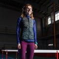 Young smiling female athlete standing near hurdle Royalty Free Stock Photo