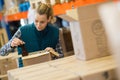 Young smiling female brewery worker with bottling Royalty Free Stock Photo