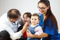 Doctors play with two young children