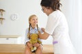 Young smiling female doctor and her little patient Royalty Free Stock Photo