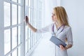 Young smiling female doctor with stethoscope looking at X-ray at doctor`s office. Royalty Free Stock Photo