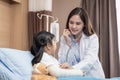 Young smiling female pediatrician doctor and child patient with teddy bear Royalty Free Stock Photo