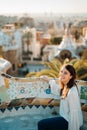 Young smiling female tourist spending vacation in Barcelona,Catalonia,Spain.Traveling to Europe,visiting Parc Guell.Panoramic view Royalty Free Stock Photo