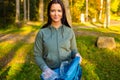 Young smiling female volunteer holding garbage bag at park