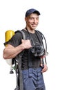 Young smiling firefighter with a mask and an air pack on his back in black t-shirt
