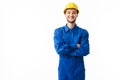 Young smiling foreman in blue uniform and yellow helmet happily looking in camera with cross hands over white background Royalty Free Stock Photo