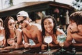 Young Smiling Friends with Cocktails at Poolside Royalty Free Stock Photo