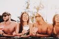 Young Smiling Friends with Cocktails at Poolside Royalty Free Stock Photo
