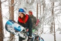 Smiling friends snowboarder going through in the fog winter fore