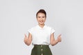 Young smiling fun happy woman of asian showing thumb up like gesture blink isolated on white background Royalty Free Stock Photo