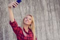 Young smiling girl with beautiful face taking self-portrait on h Royalty Free Stock Photo