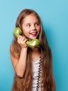 Young smiling girl with green handset