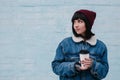 Young smiling girl hipster hot drink in hand, on a light background Royalty Free Stock Photo