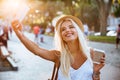 Young smiling girl making selfie while standing on the street Royalty Free Stock Photo