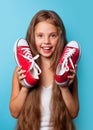 Young smiling girl with red gumshoes