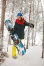 Smiling girl snowboarder going through in the fog winter forest Royalty Free Stock Photo