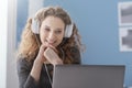 Girl with headphones watching films online
