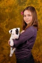 Young smiling girl with white bullterrier puppy. Royalty Free Stock Photo