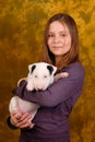 Young smiling girl with white bullterrier puppy. Royalty Free Stock Photo