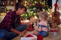 Young girls opening gifts.Cheerful Christmas gift at home