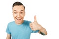 Young smiling guy, dressed in a blue t-shirt, show thumbs up on a isolated white background Royalty Free Stock Photo