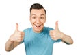 Young smiling guy, dressed in a blue t-shirt, show thumbs up on a isolated white background Royalty Free Stock Photo