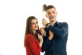 Young smiling guy with girl, hold near face paper props in the form of lips, moustache and hats for a photo Royalty Free Stock Photo