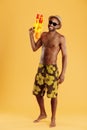 Young smiling handsome black man holding water gun Royalty Free Stock Photo