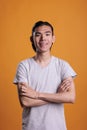 Young smiling happy asian man standing with arms crossed Royalty Free Stock Photo