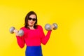 Young smiling happy chubby overweight plus size big fat fit woman warm up training hold dumbbells Royalty Free Stock Photo