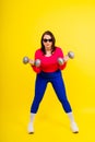 Young smiling happy chubby overweight plus size big fat fit woman warm up training hold dumbbells Royalty Free Stock Photo