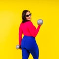 Young smiling happy chubby overweight plus size big fat fit woman warm up training hold dumbbells Royalty Free Stock Photo