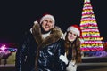 A young smiling happy married couple in the Red cap at Christmas outdoors Royalty Free Stock Photo