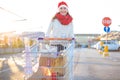 Young smiling happy woman with a lot of gift boxes in shopping cart Royalty Free Stock Photo