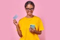 Young smiling Indian woman holds phone and recommends ordering bank credit card Royalty Free Stock Photo