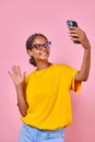 Young smiling Indian woman teenager says hello and shoots vlog on phone camera Royalty Free Stock Photo