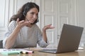 Young smiling Italian woman freelancer in headset consulting client customer via video call