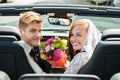 Just Married Couple With Bouquet In The Car Royalty Free Stock Photo