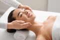 Young Smiling Korean Woman Enjoying Spa Facial Massage In Beauty Salon Royalty Free Stock Photo