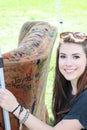 Young smiling lady holding onto a couch