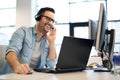 Young smiling male call center operator doing his job with a headset.Portrait of call center worker at office. Royalty Free Stock Photo