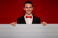 Young smiling man with blank red sign board Royalty Free Stock Photo