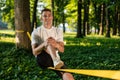 Young smiling man in the forest practising slacklining Royalty Free Stock Photo