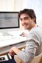 Young smiling man in front of computer Royalty Free Stock Photo