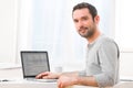 Young smiling man in front of a computer Royalty Free Stock Photo